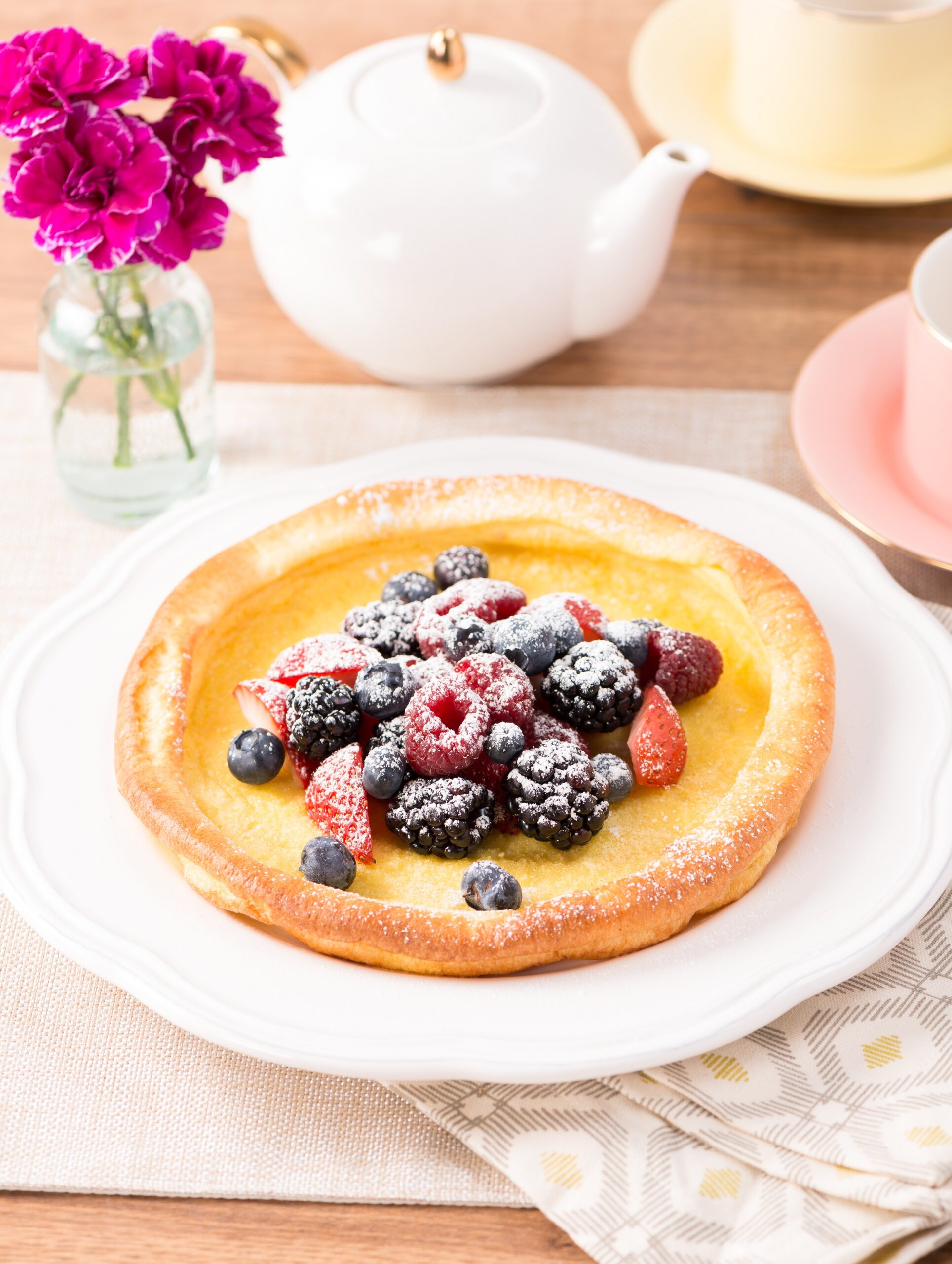 Fresh berry Dutch baby pancake on table