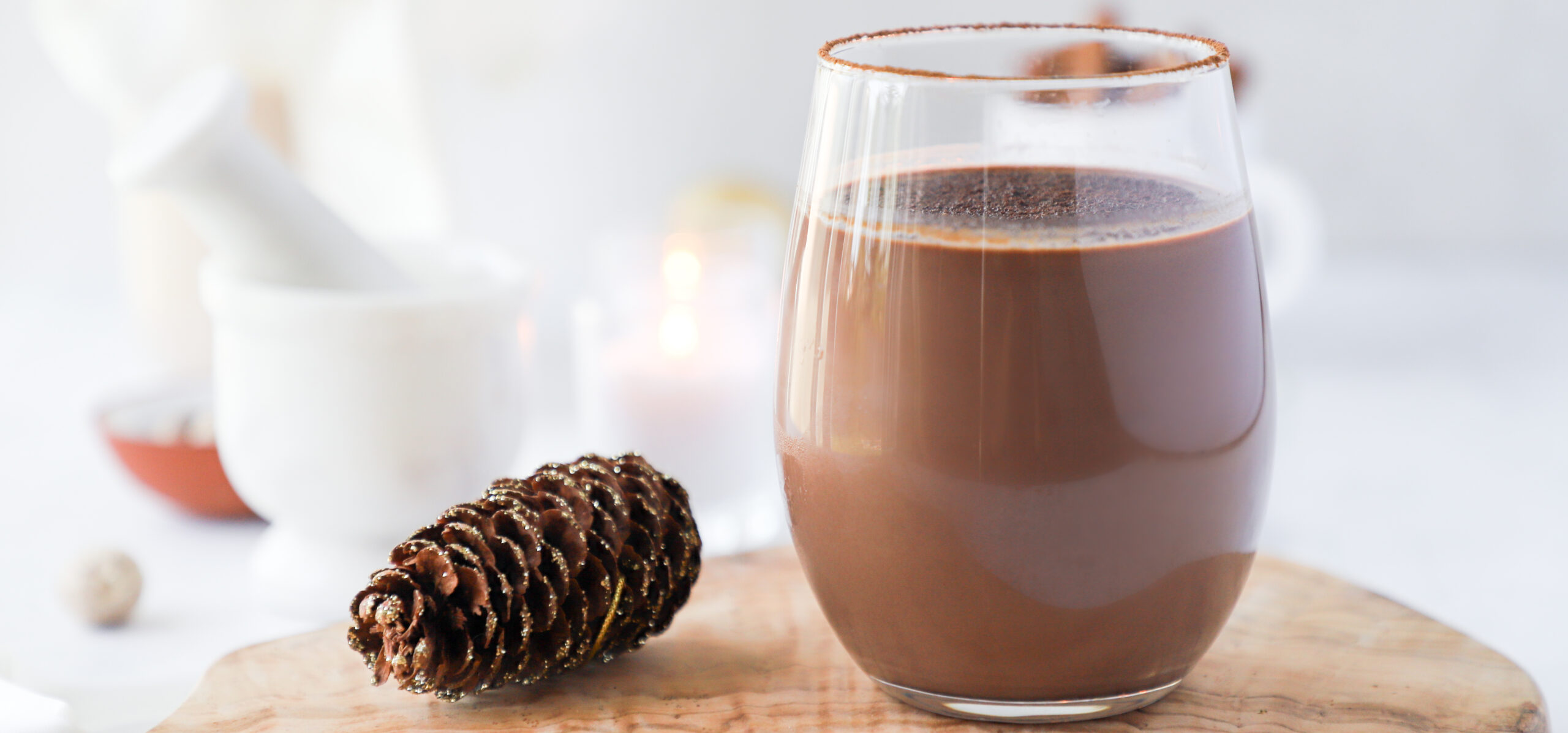 Glass of chocolate milk on wooden board